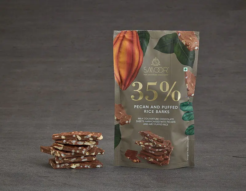 ad173dcdb290372429cee1c3edd0bc00.webp Smoor Chocolates - CHOCOLATE BARKS - PECAN AND PUFFED RICE BARKS MRP 400 - Image 1
